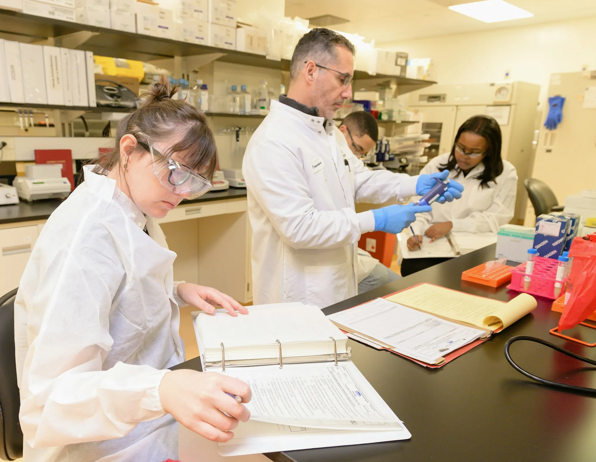 Lab analysts recording results at a bench